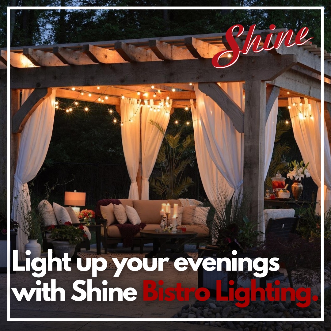 An inviting outdoor pergola features Shine Bistro Lighting, sheer drapes, and comfortable seating for evening
