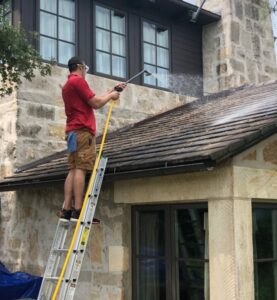 Shine employee washing a roof