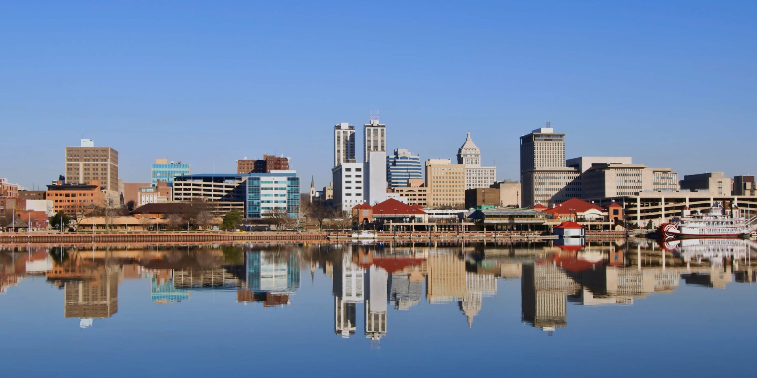 Shreveport, Louisiana skyline with a riverboat casino perfectly reflected in the calm Red River.