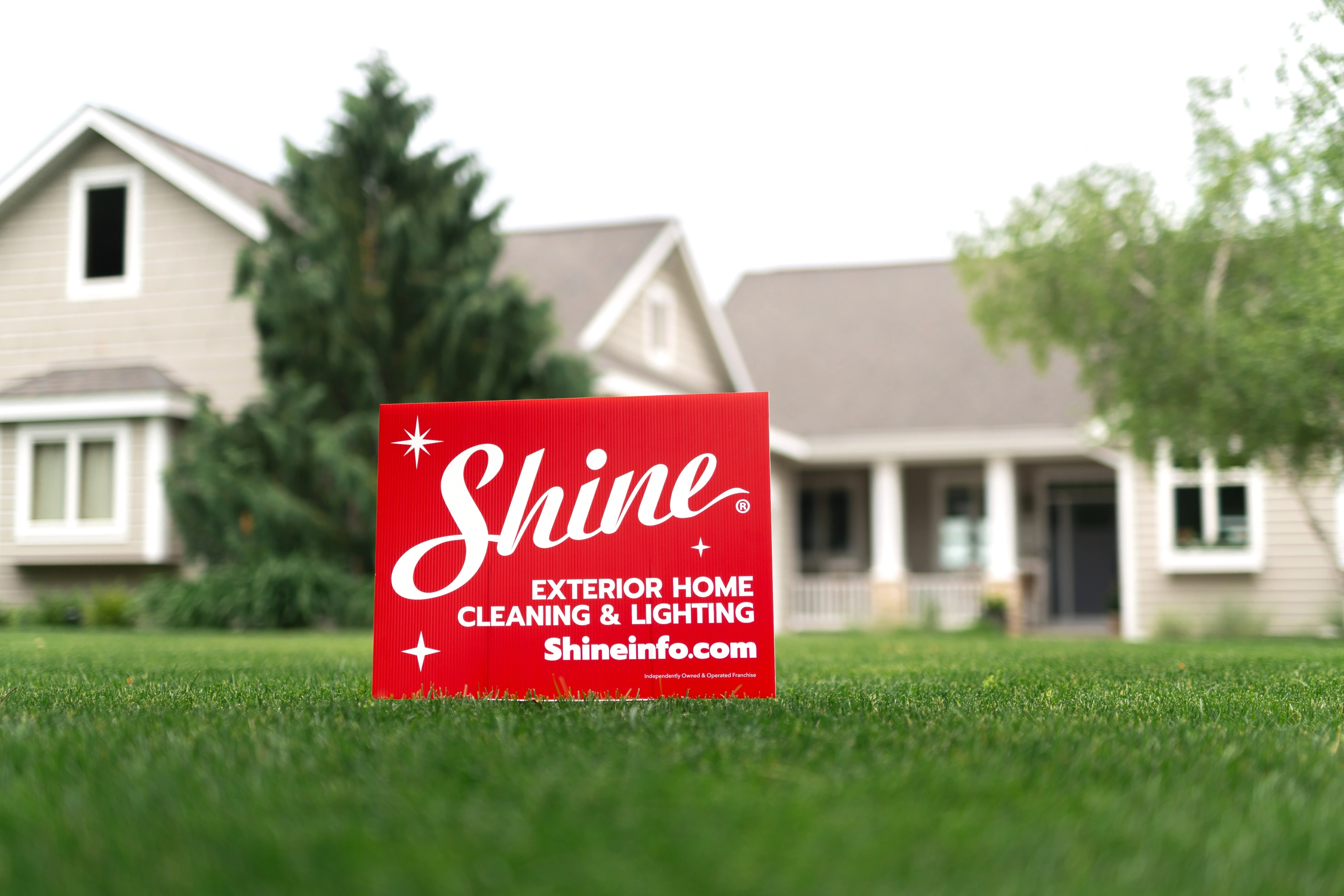 Shine yard sign in front of a residential home