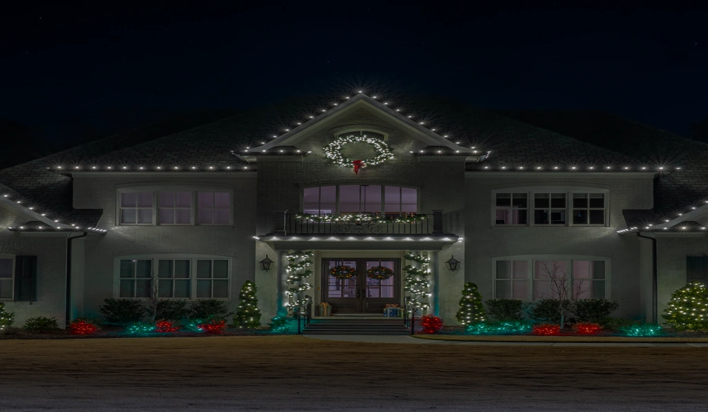 Two-story home decorated with professional holiday lighting