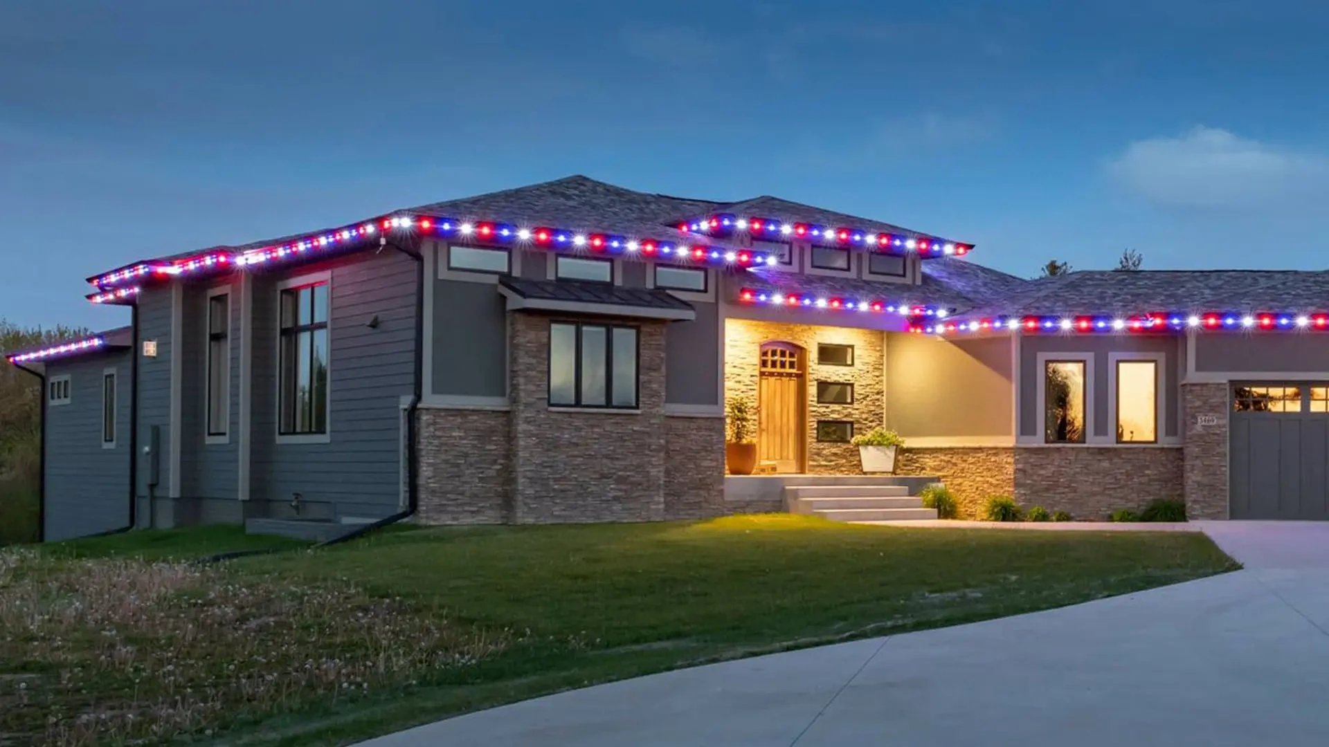 Modern home with red, white, and blue holiday lighting