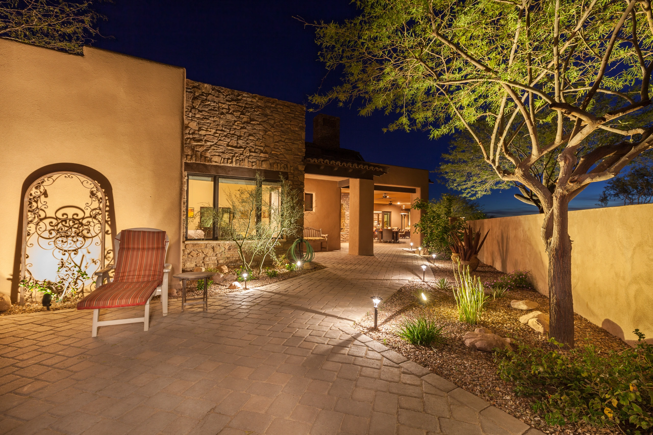 Patio and walkway with warm landscape lighting