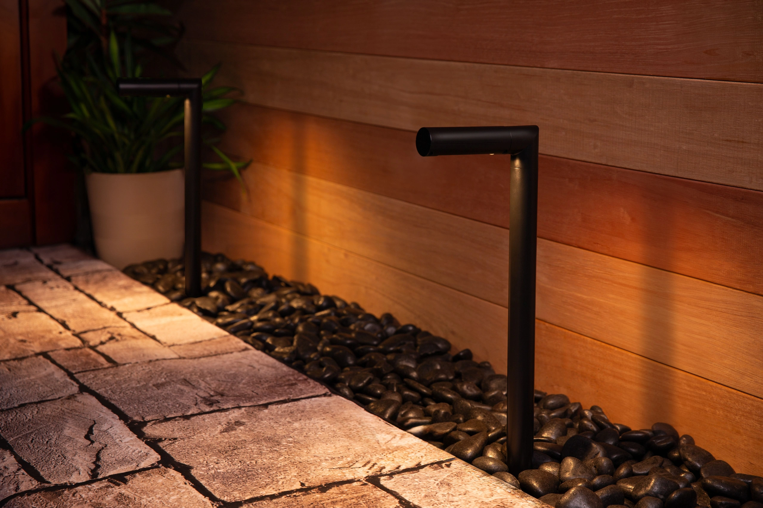 Outdoor path lights along a fence
