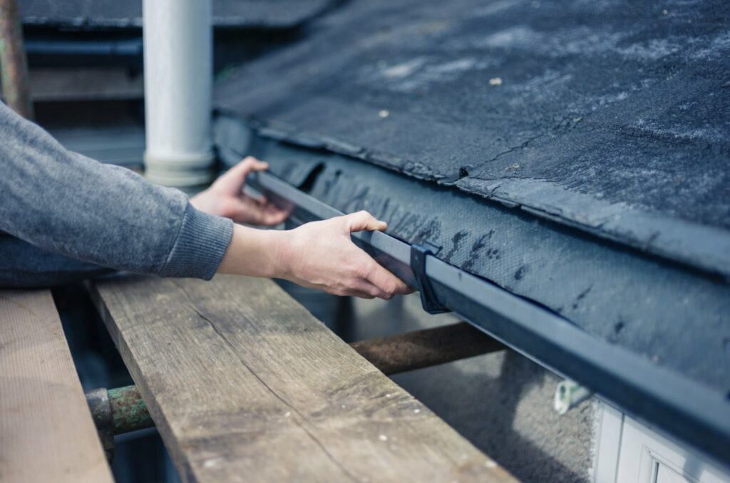 Hand grabbing gutters