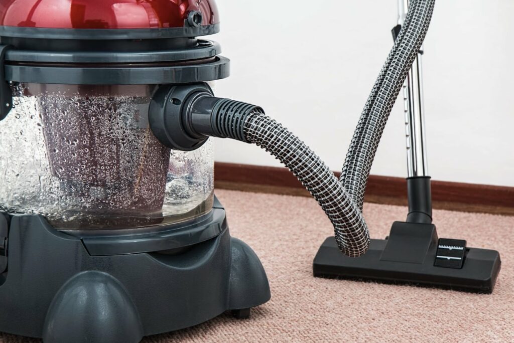 A red canister vacuum cleaner.