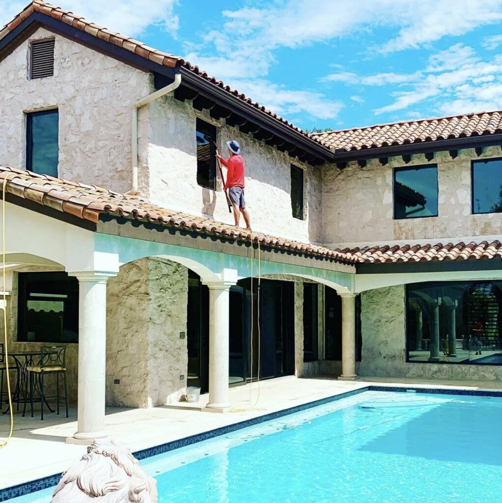 Shine window cleaners cleaning a house with a pool in westlake