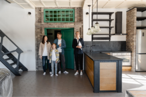 Real estate agent giving a family a tour of a house