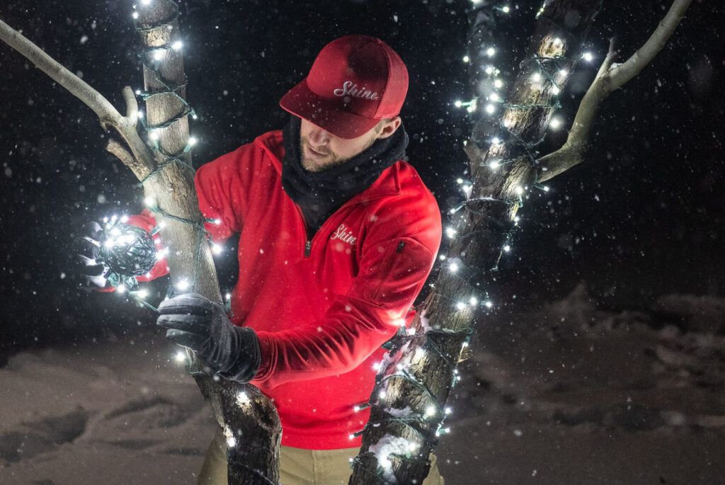 A Shine of Denver team member installing Christmas Lights