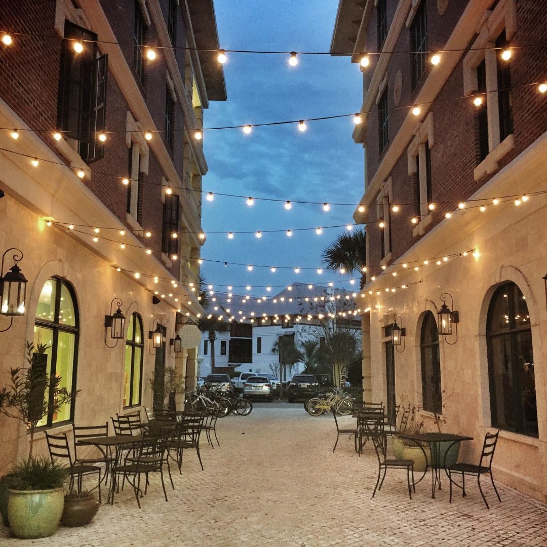Warm bistro string lights over an outdoor patio