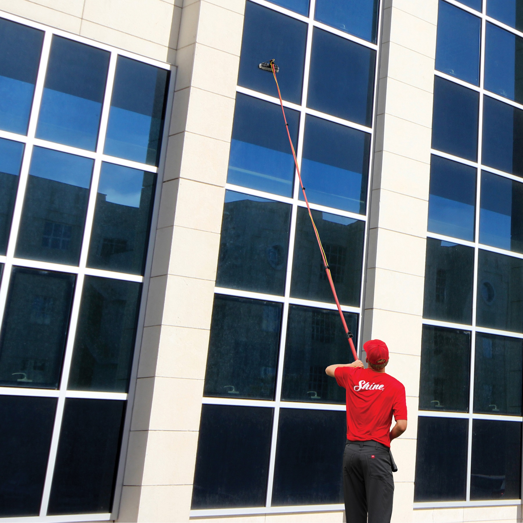 Shine technicians on ladders working along a residential roofline
