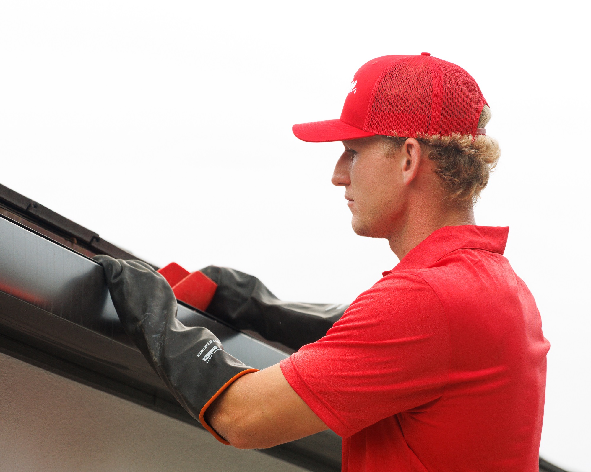 Shine technicians on ladders working along a residential roofline