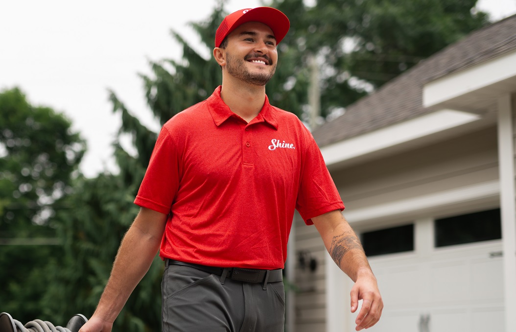 Shine team member holding a squeegee