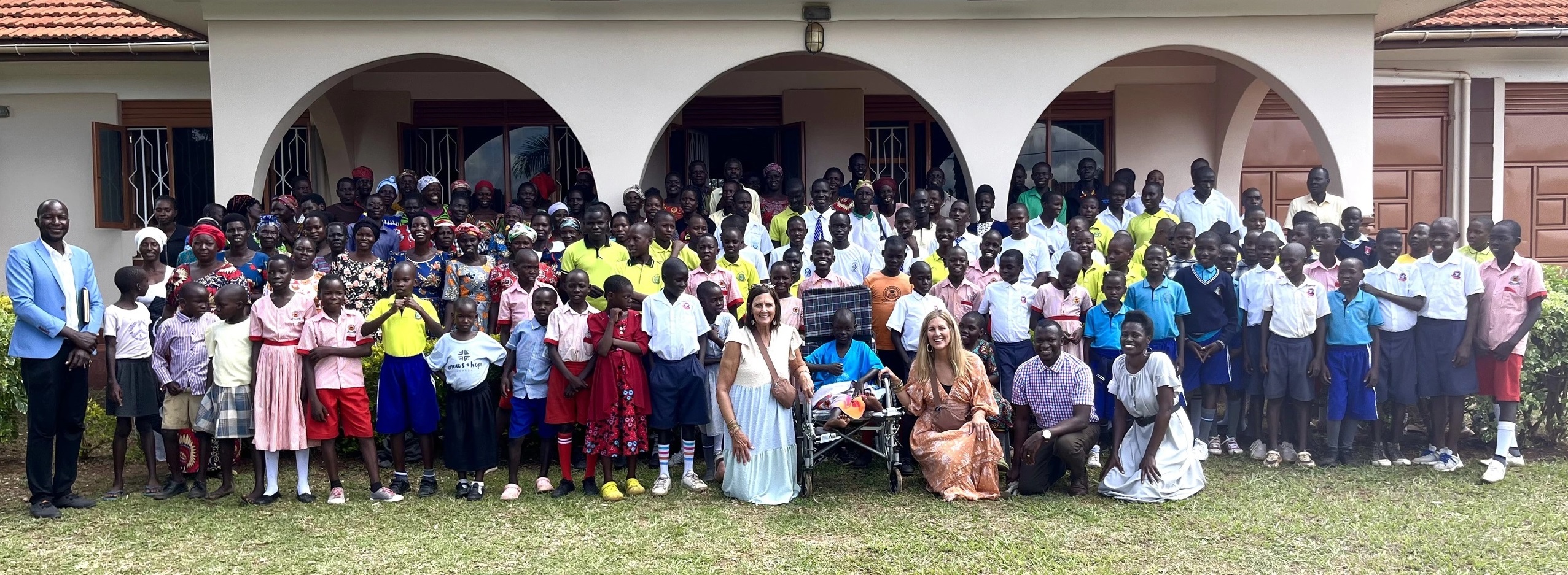 Arrows + Hope students and Shine founders gathered outside a school in Uganda