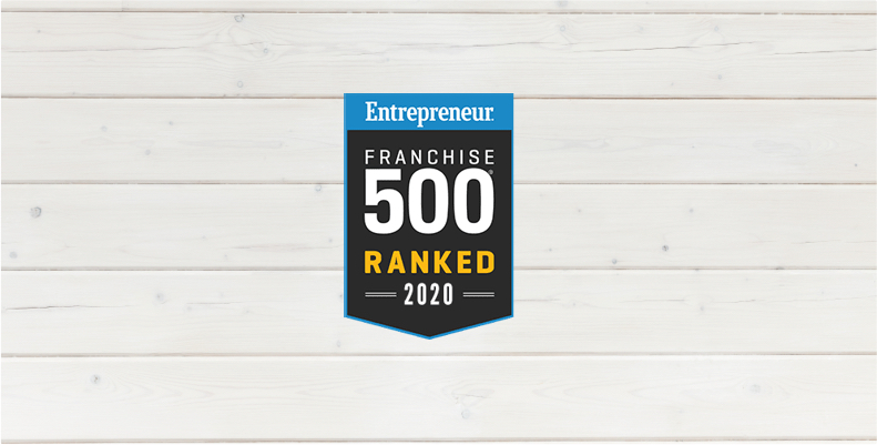 An Entrepreneur Franchise 500 Ranked 2020 badge is displayed on a white wooden